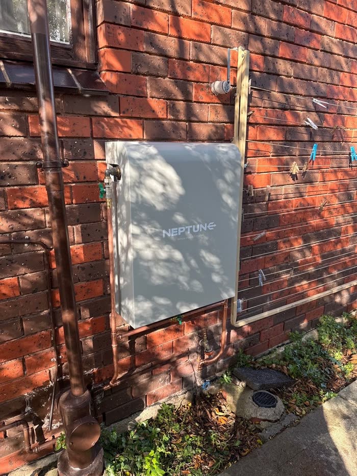 Neptune whole home filtration system installed on a red brick home, Noble Park